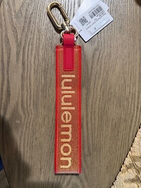 lululemon Red and Gold Logo Wrist Strap Keychain